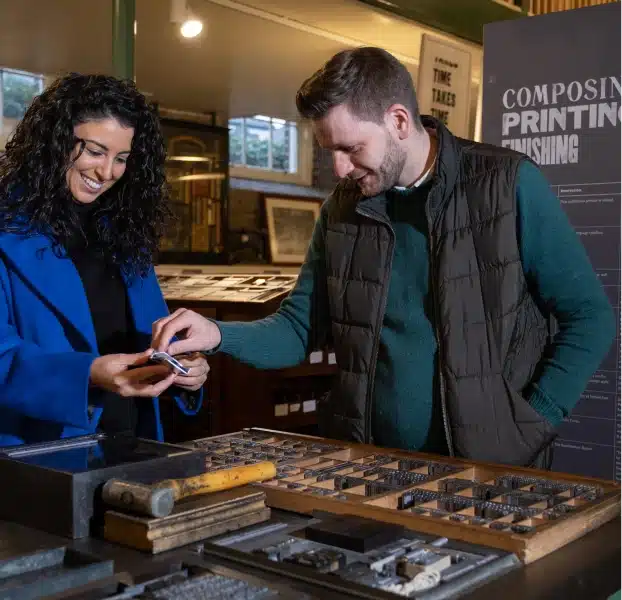 man and woman looking at print tools