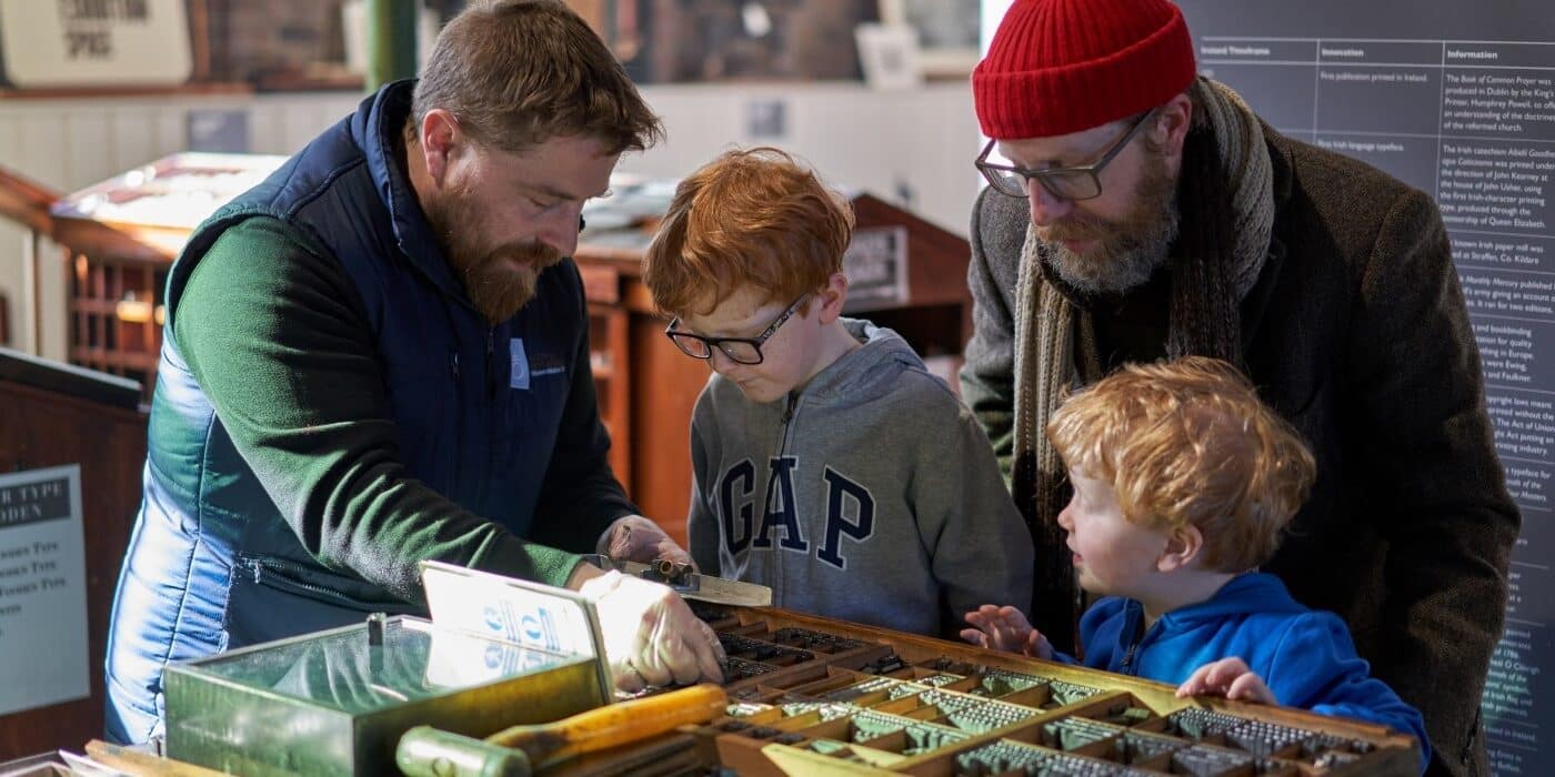 Children composing type on a tour