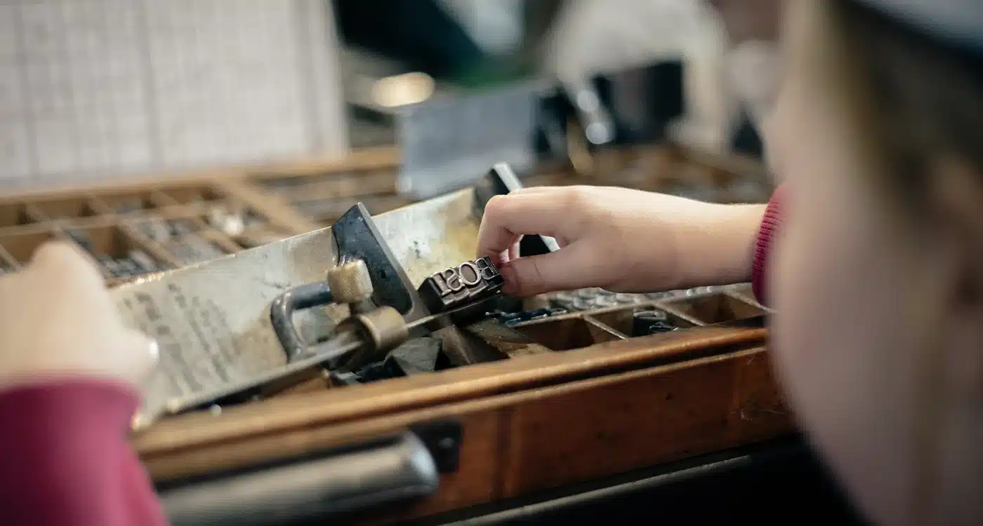 Girl examining type pieces