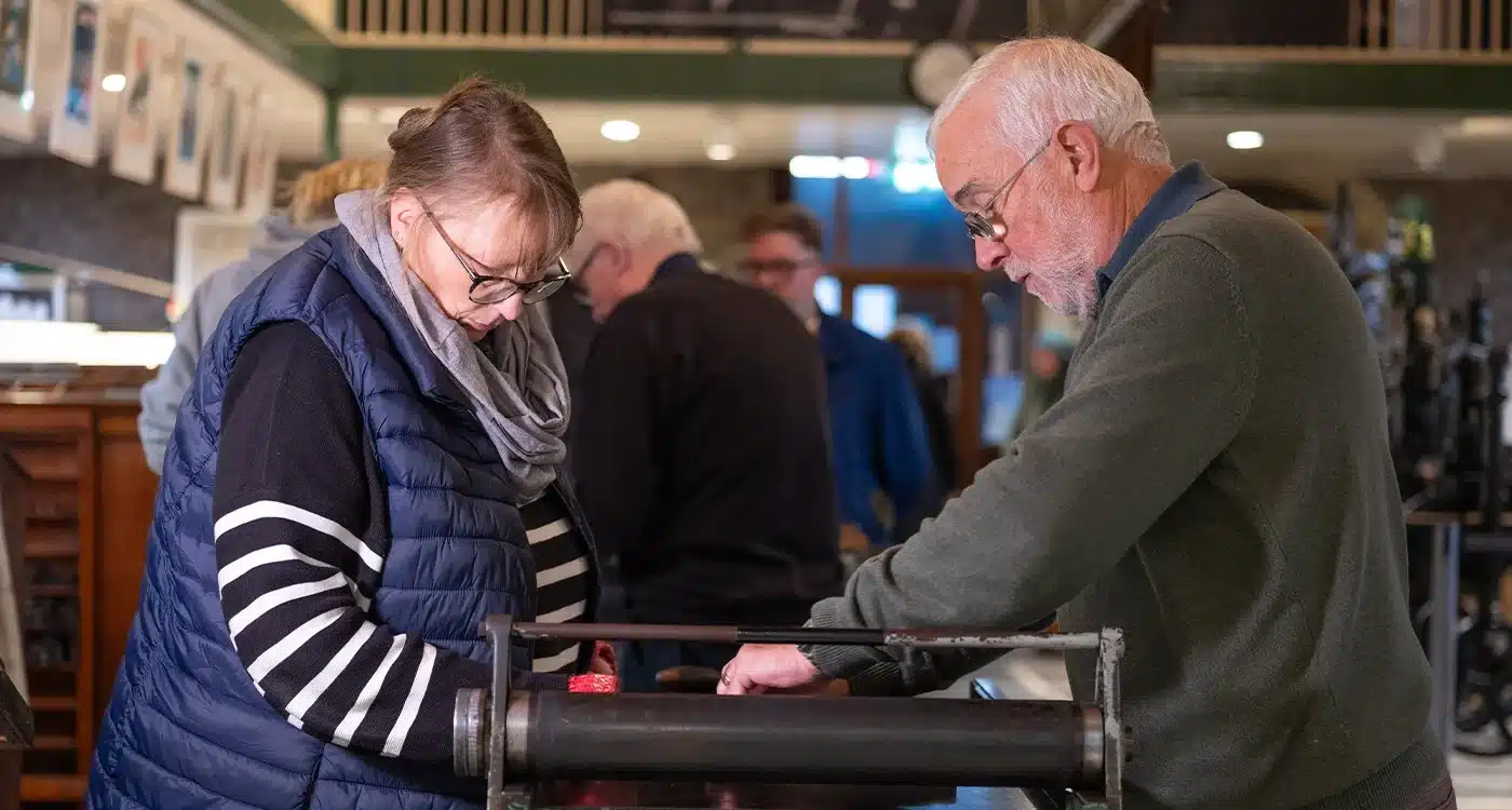 Students on QQ5 course working on the printer press