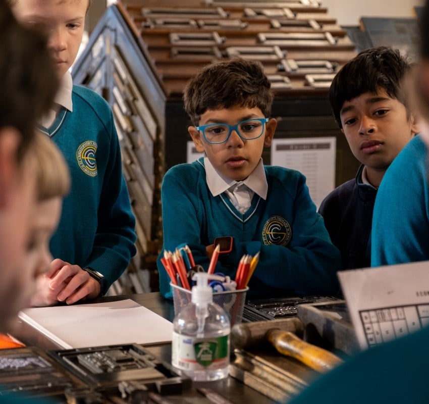 primary school students listening to a tour at the composing stone