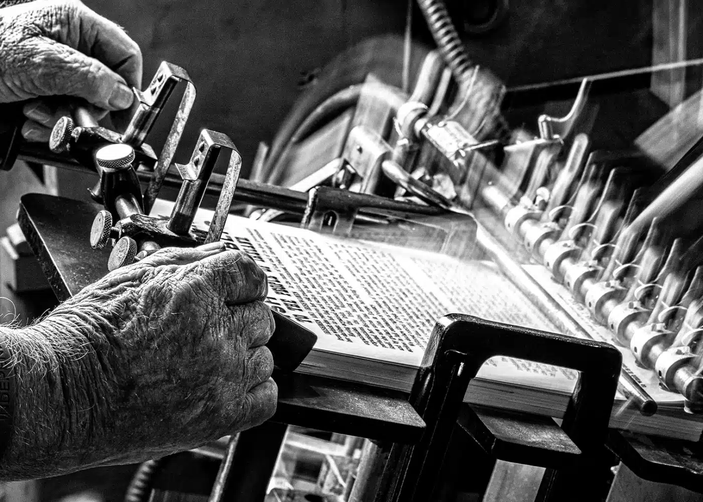 Black and White Image of Man working printing Press