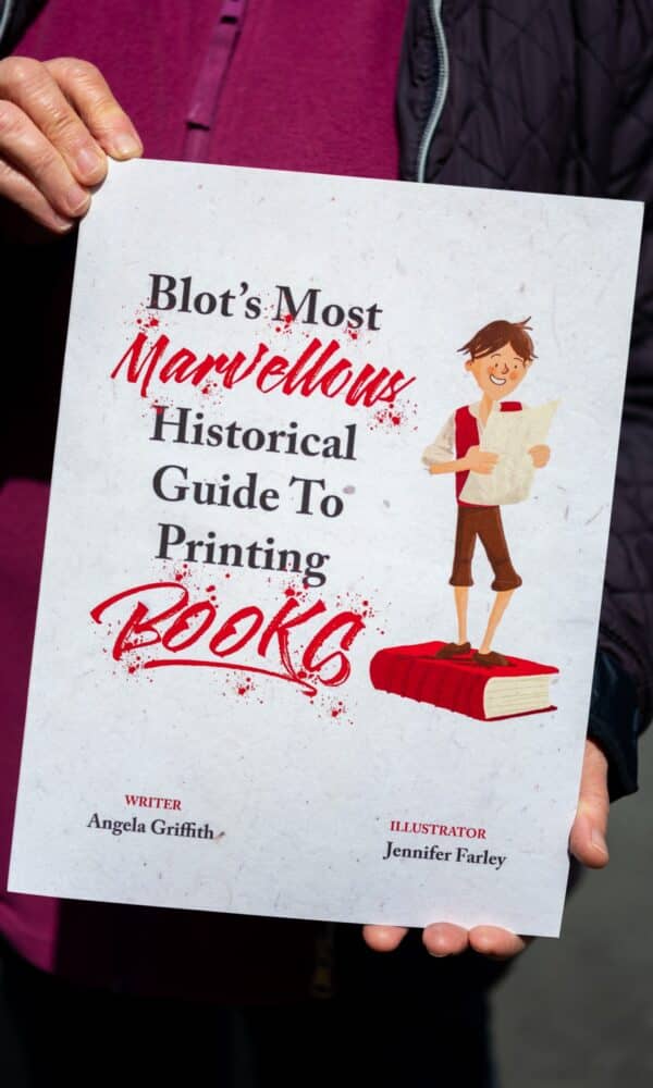 Someone holding the softback copy of 'Blots Most Marvellous Hsitorical Guide to Printing Books'