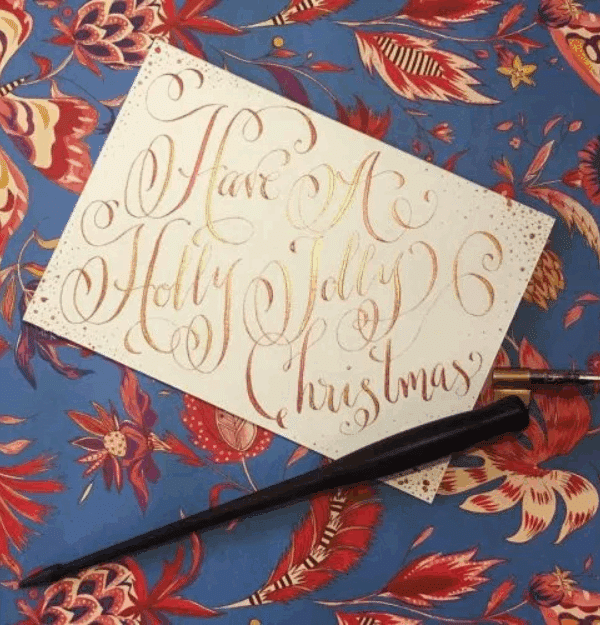 a christmas card with a note in elaborate, festive calligraphy