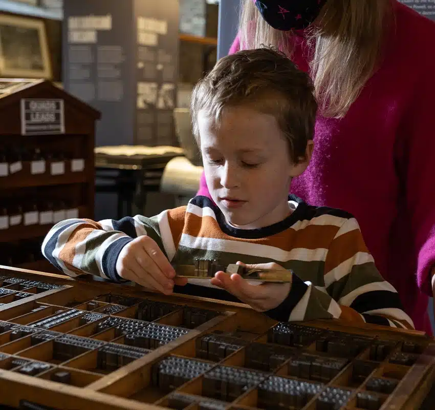 Kid looking at type drawer