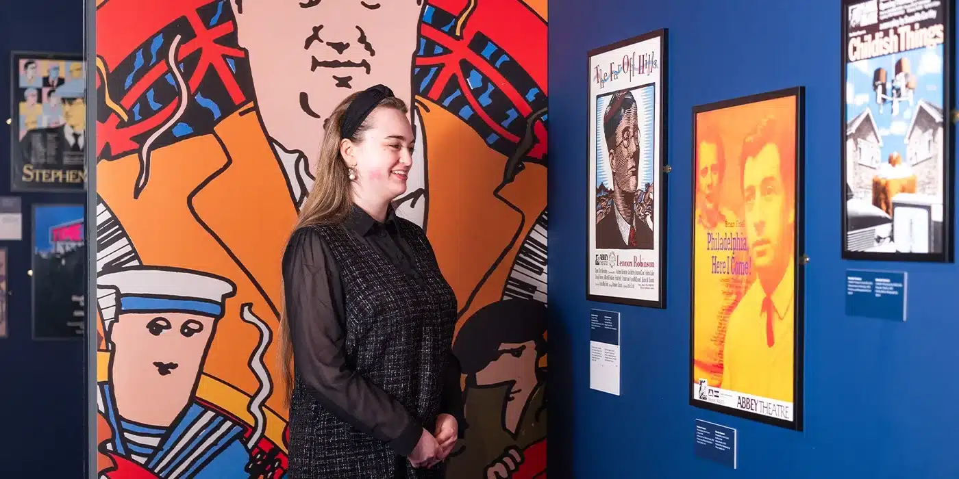 Poster boys exhibition woman looking at prints