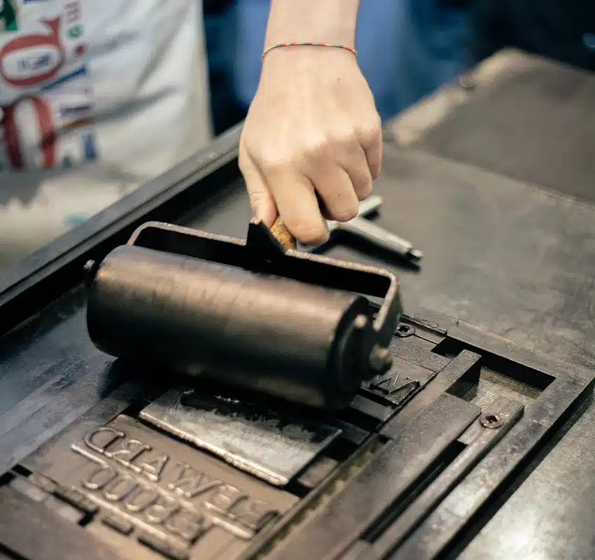Rolling pin spreading ink of metal plate