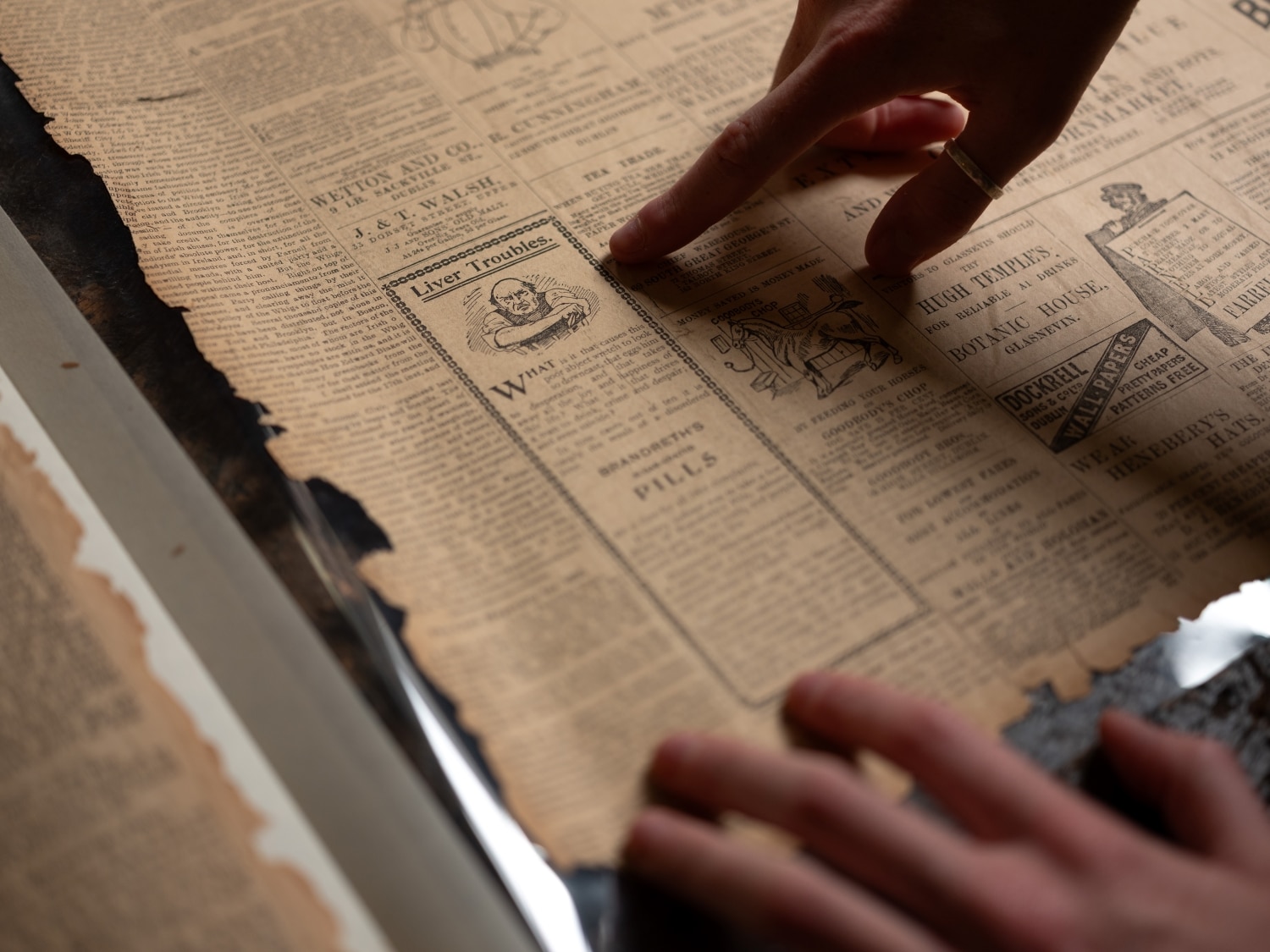 An intern points out an ad for Brandreth's Pills in an 1894 Evening Herald newspaper