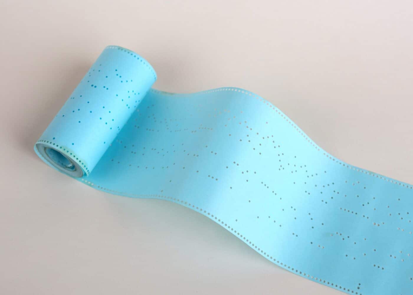Roll of monotype paper, showing the holes punched in by the keyboard
