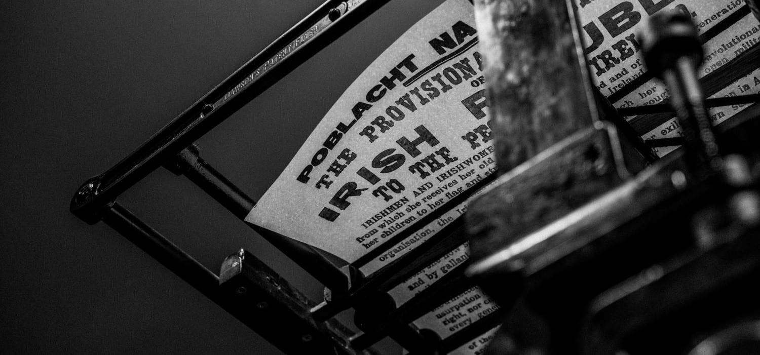 A replica copy of the Proclamation resting on the drying rack of a Wharfdale printing press, seen from below