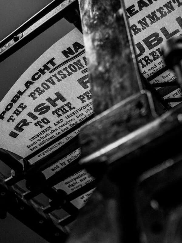 A replica copy of the Proclamation resting on the drying rack of a Wharfdale printing press, seen from below