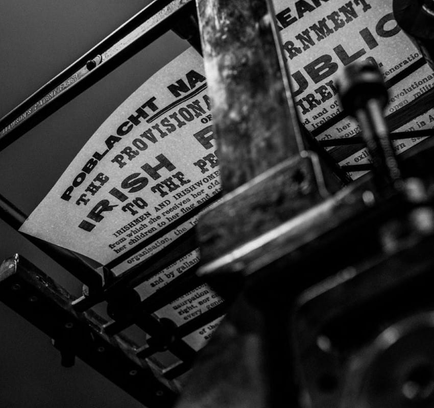 A replica copy of the Proclamation resting on the drying rack of a Wharfdale printing press, seen from below