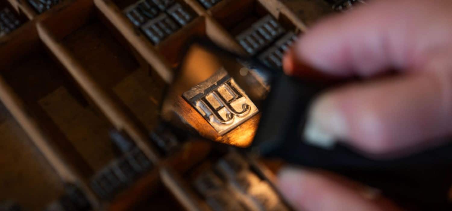 a case of type seen through a magnifying glass, focus on a single piece of type