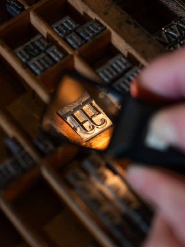 a case of type seen through a magnifying glass, focus on a single piece of type