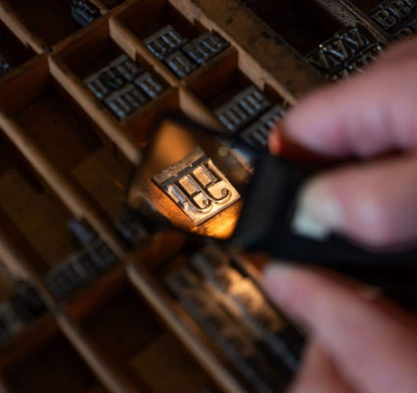 a case of type seen through a magnifying glass, focus on a single piece of type