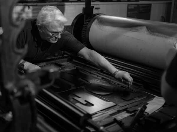 Hope print being tightened onto the bed of a Wharfdale stop cylinder press
