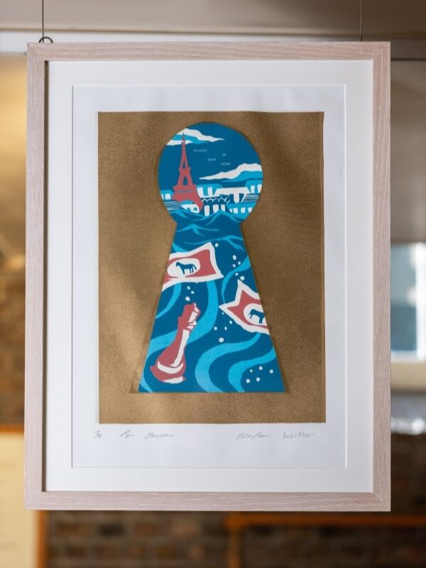 A print showing various monuments and sea waves through a keyhole