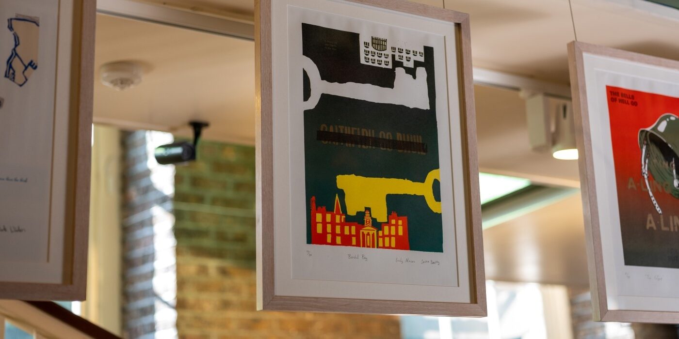A row of framed prints inspired by plays of Brendan Behan