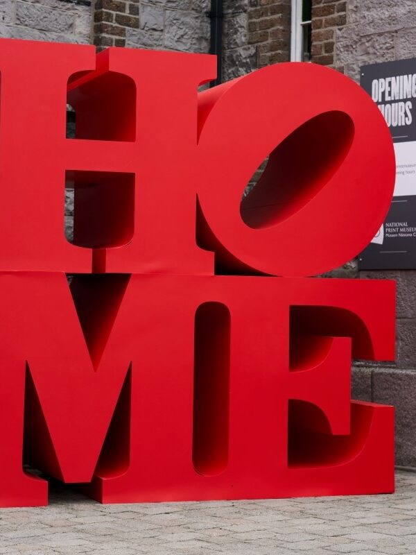 Red sculpture reading HOME, in the style of the famous LOVE sculpture