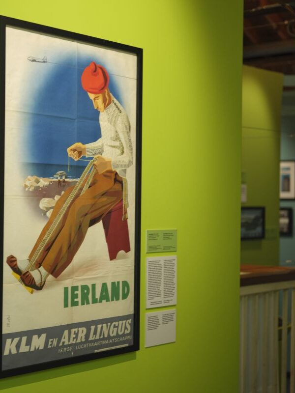 A poster advertising travel to Ireland hung on a bright green wall.