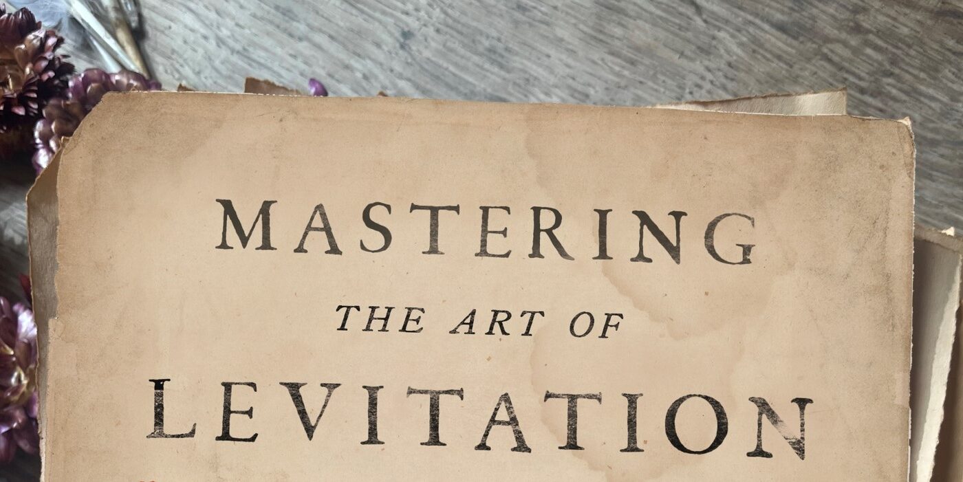 The top part of an old-looking book which reads Mastering the Art of Levitation.