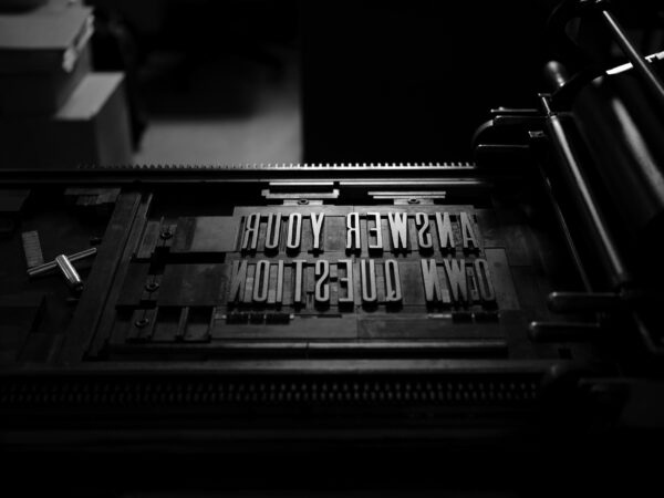 A letterpress forme set into a press to print.