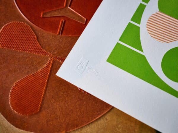 The corner of a letterpress print is shown featuring the logo of the National Print Museum where it was printed.