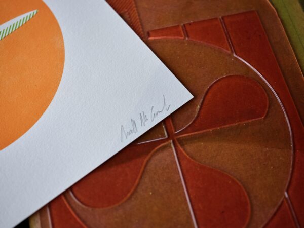 The corner of a letterpress print is shown featuring the designer's signature, Niall McCormack.